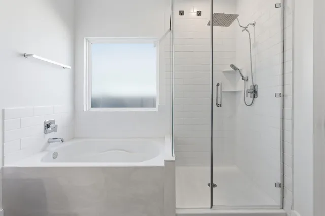 a bathroom with a bathtub and a shower