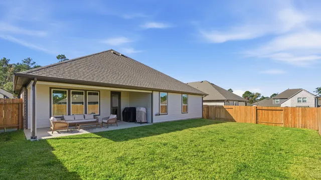 a view of a house with a backyard