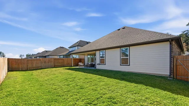 a view of a house with a yard and pathway