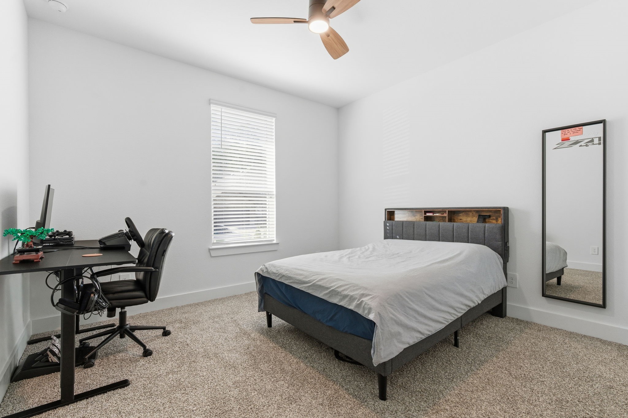 13776 Rising Sun Lane Conroe, TX 77384 - Photo 18 of 30 a bedroom with a bed table chair and a window