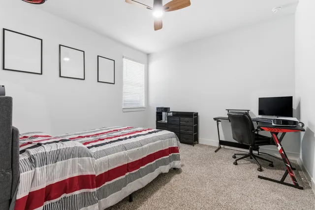 a bedroom with a bed and a chair