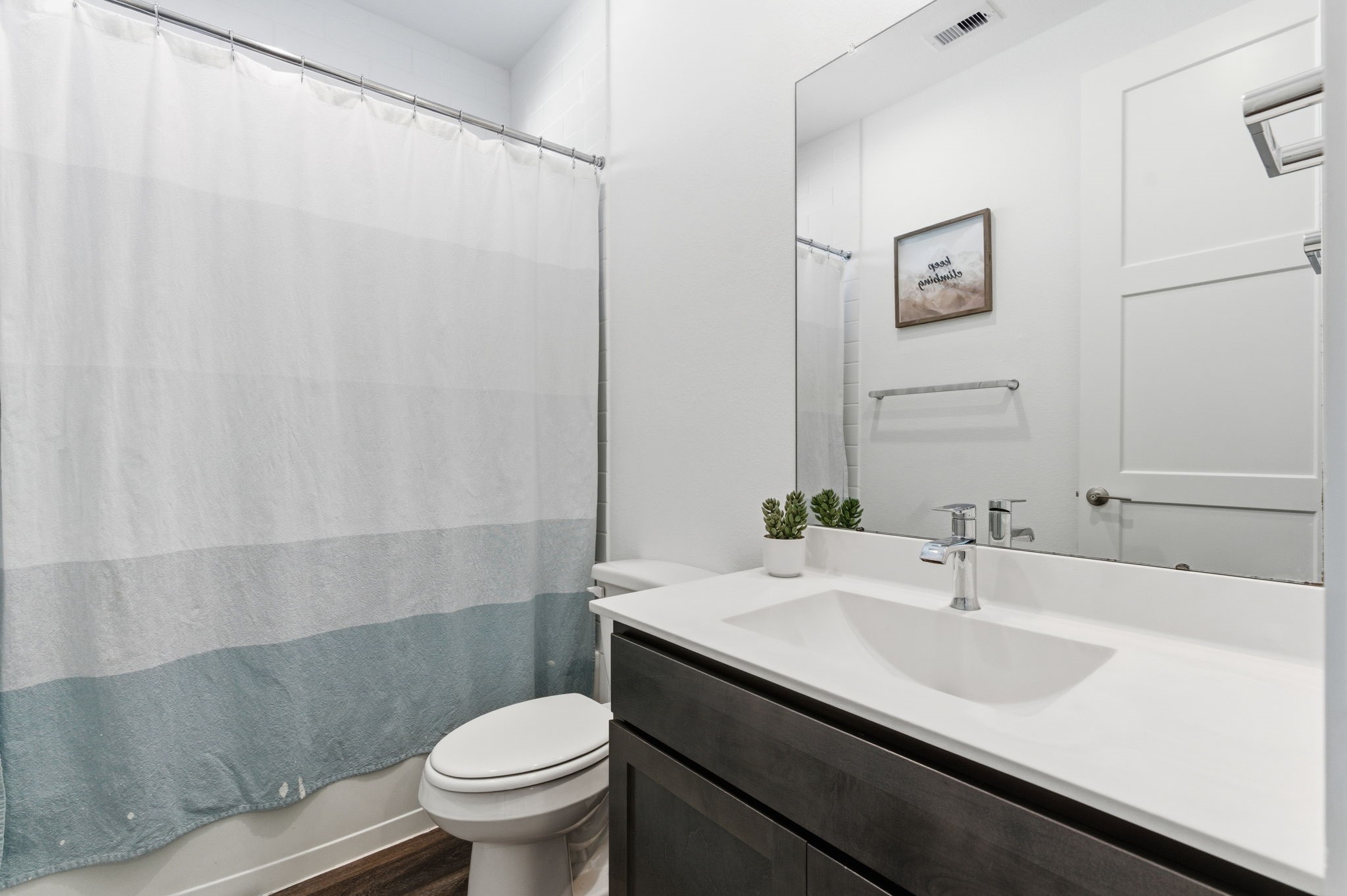 13776 Rising Sun Lane Conroe, TX 77384 - Photo 20 of 30 a bathroom with a sink a toilet and a mirror