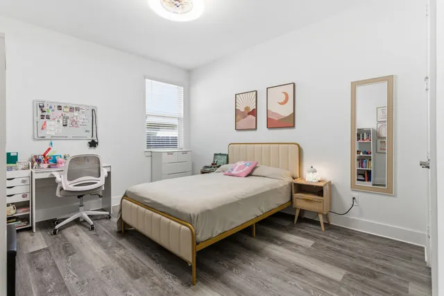 a bedroom with a bed and a table in it