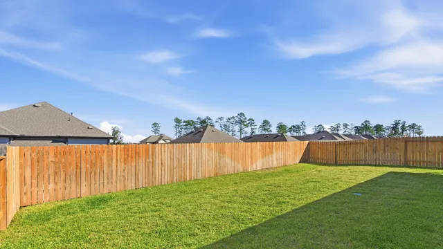 a view of yard with swimming pool and green space
