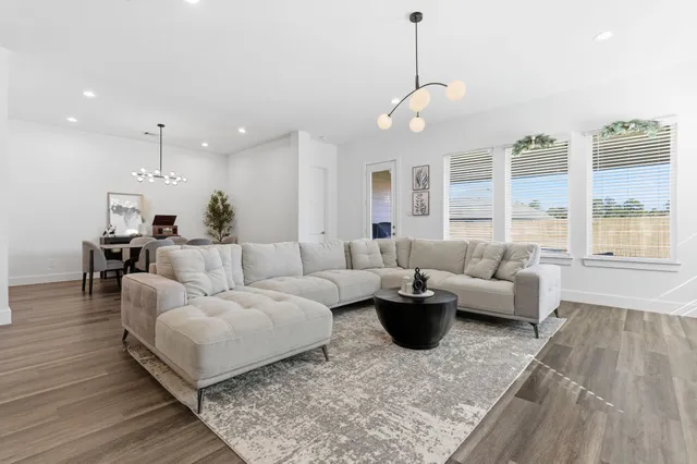 a living room with furniture and a large window