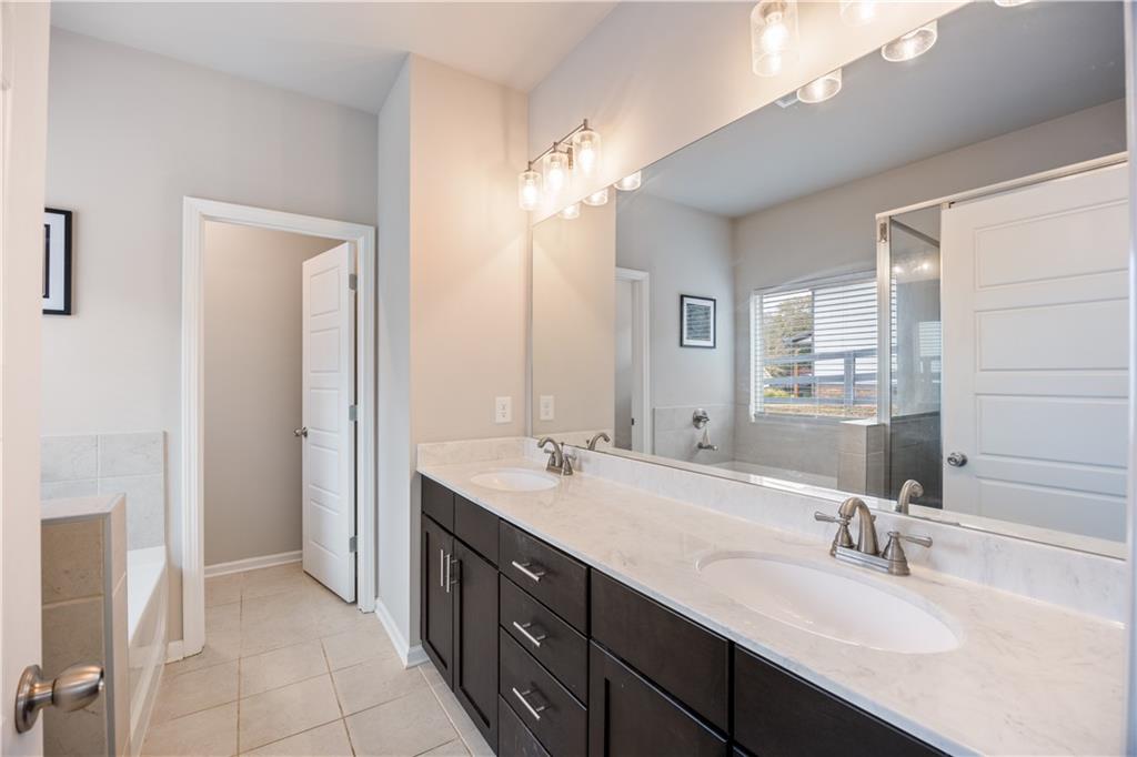 184 Ashford Lane Commerce, GA 30529 - Photo 12 of 49 a bathroom with a double vanity sink a mirror and a