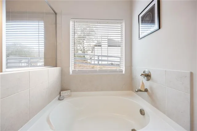 a white bath tub sitting next to a window
