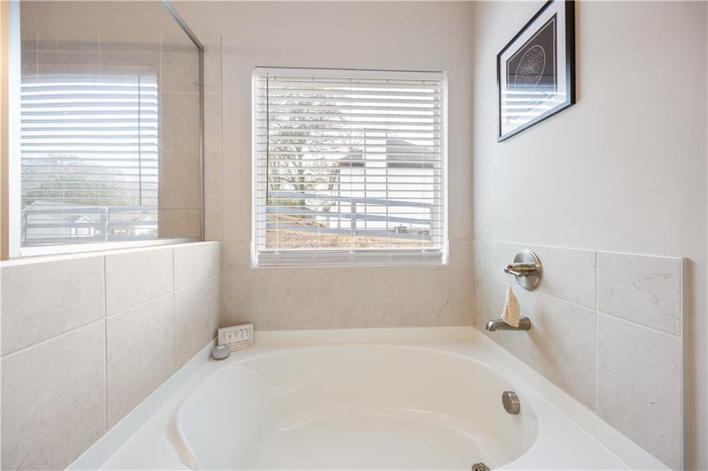 184 Ashford Lane Commerce, GA 30529 - Photo 14 of 49 a white bath tub sitting next to a window