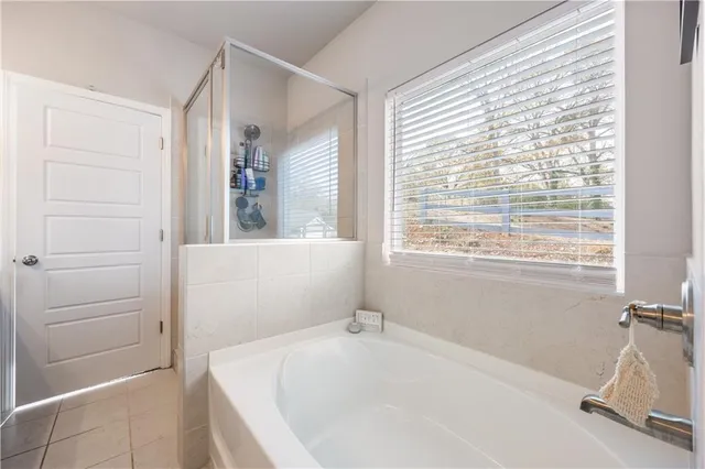 a bathroom with a tub and a window