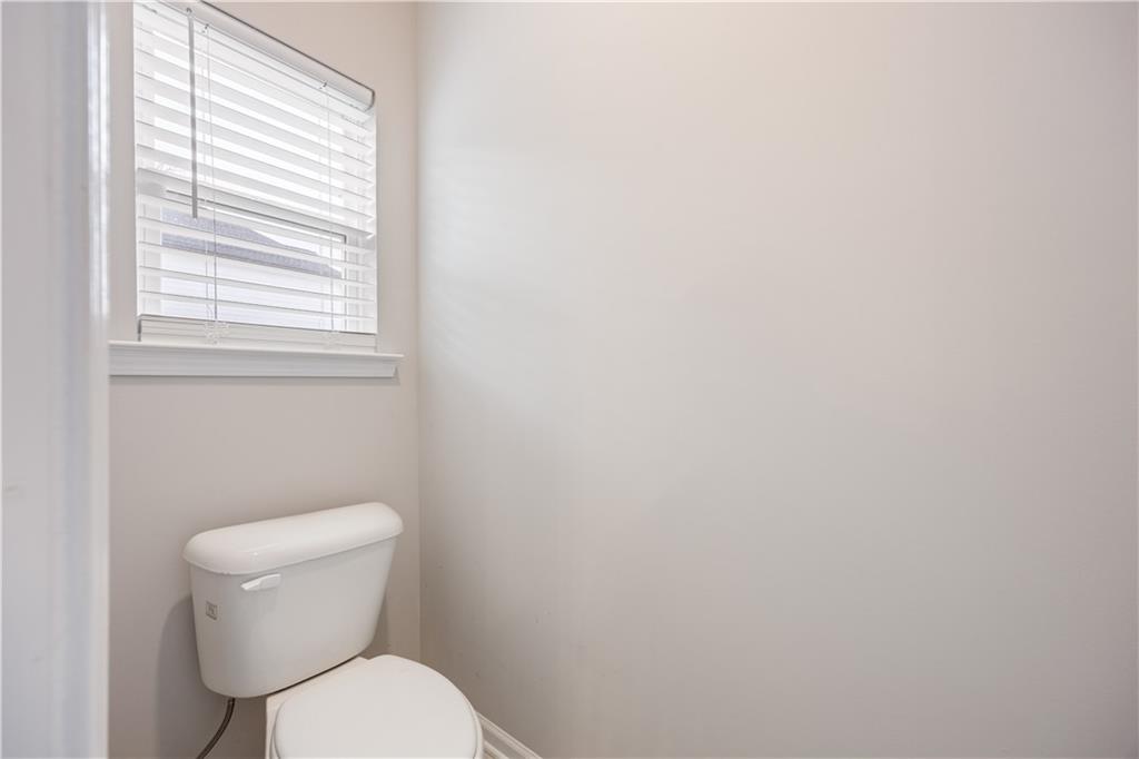 184 Ashford Lane Commerce, GA 30529 - Photo 16 of 49 a white toilet sitting next to a window