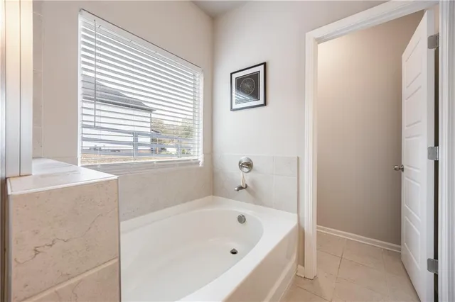 a bathroom with a bathtub and a window