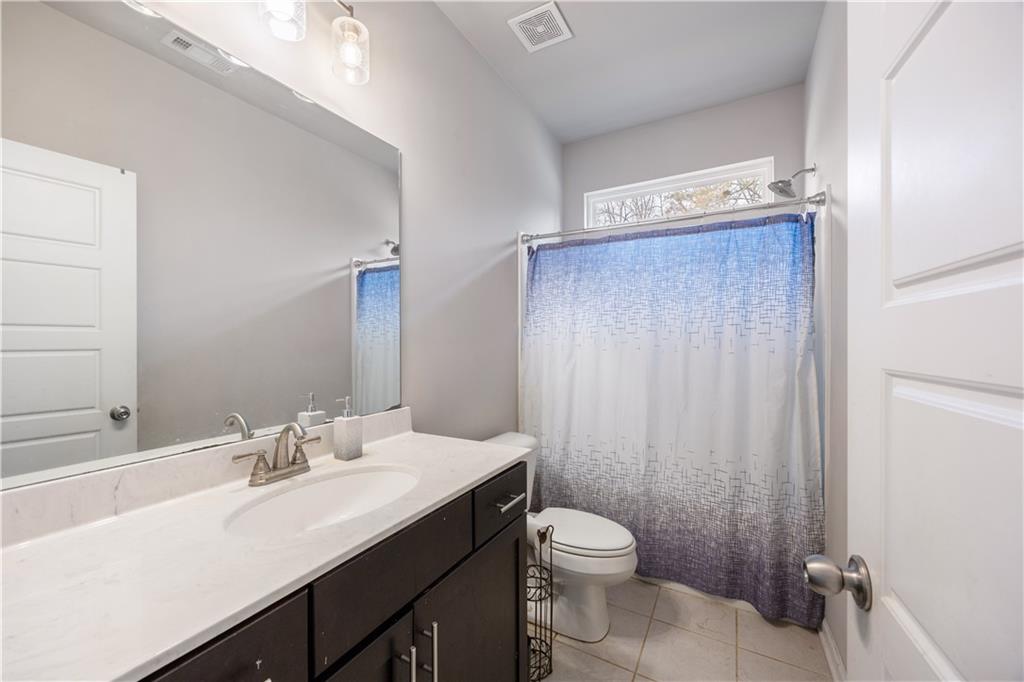 184 Ashford Lane Commerce, GA 30529 - Photo 20 of 49 a bathroom with a sink a toilet and shower