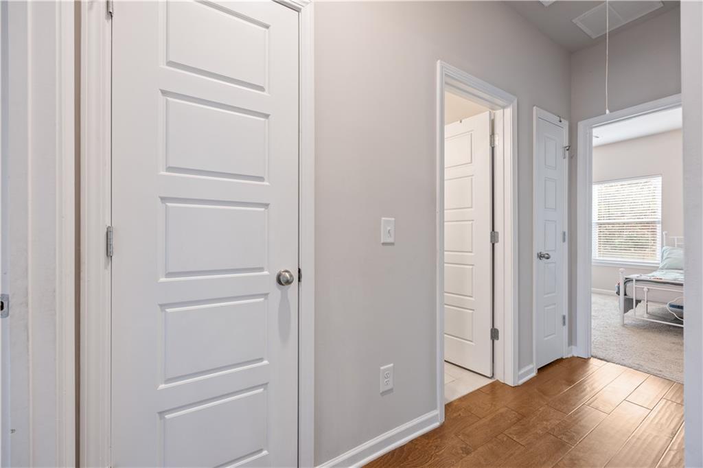 184 Ashford Lane Commerce, GA 30529 - Photo 21 of 49 a view of a hallway with bathroom and wooden floor
