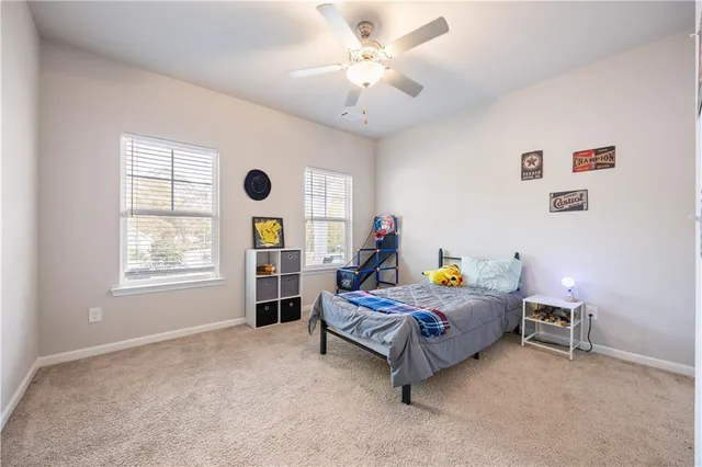 a bedroom with a bed a chandelier and a window