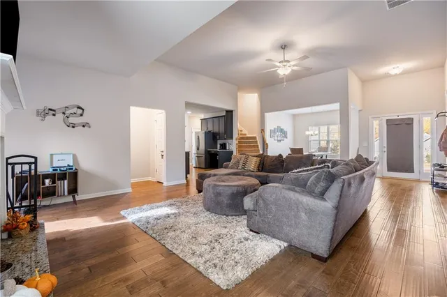 a living room with furniture and wooden floor