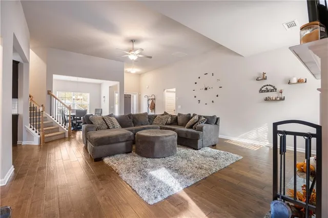 a living room with furniture or wooden floor and a chandelier