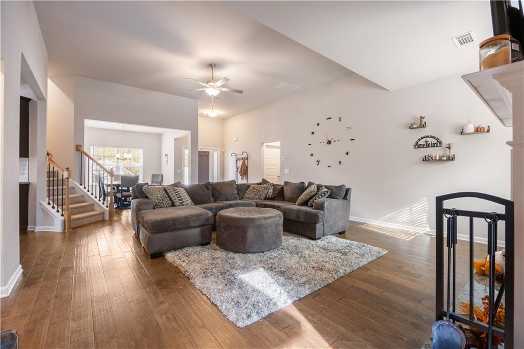 184 Ashford Lane Commerce, GA 30529 - Photo 29 of 49 a living room with furniture or wooden floor and a chandelier