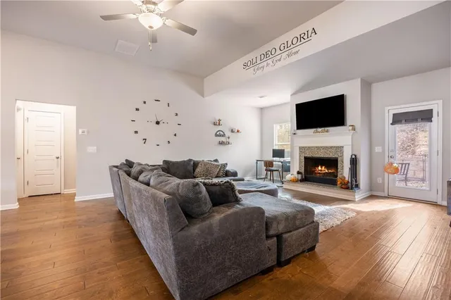 a living room with furniture a flat screen tv and a fireplace