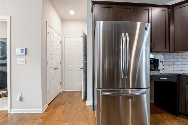 a metallic refrigerator freezer sitting in a kitchen