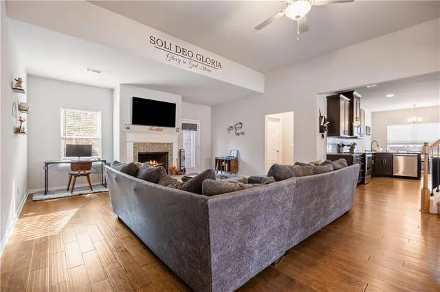 a living room with fireplace furniture and a flat screen tv