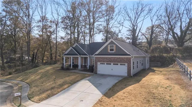 a view of a house with backyard and sitting area