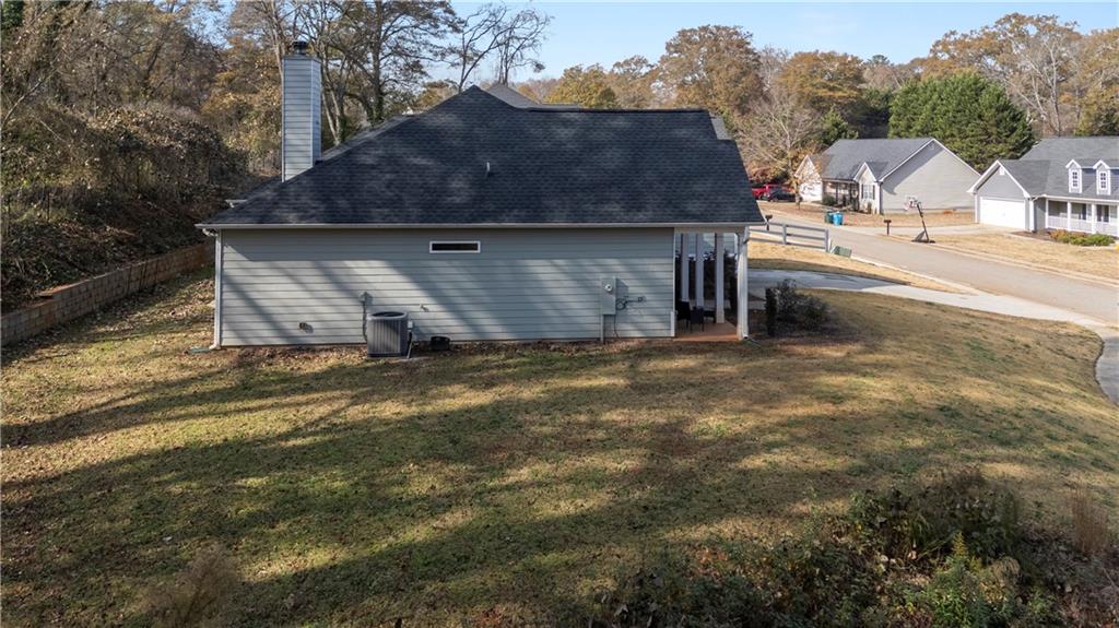 184 Ashford Lane Commerce, GA 30529 - Photo 46 of 49 a front view of house with yard and trees in the background