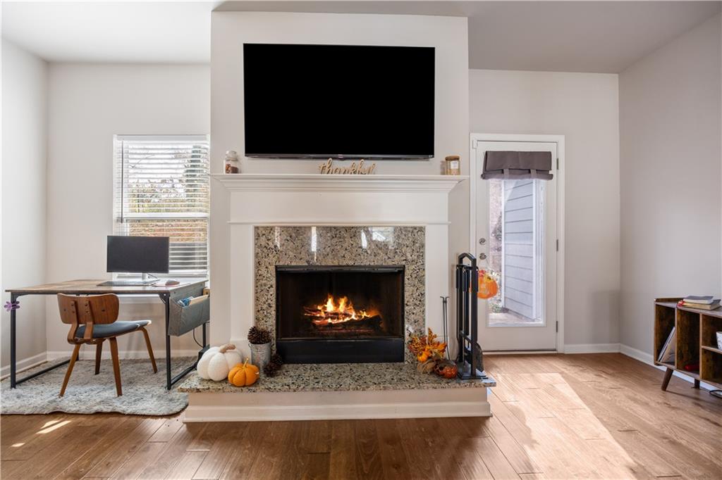 184 Ashford Lane Commerce, GA 30529 - Photo 5 of 49 a living room with furniture a flat screen tv and a fireplace
