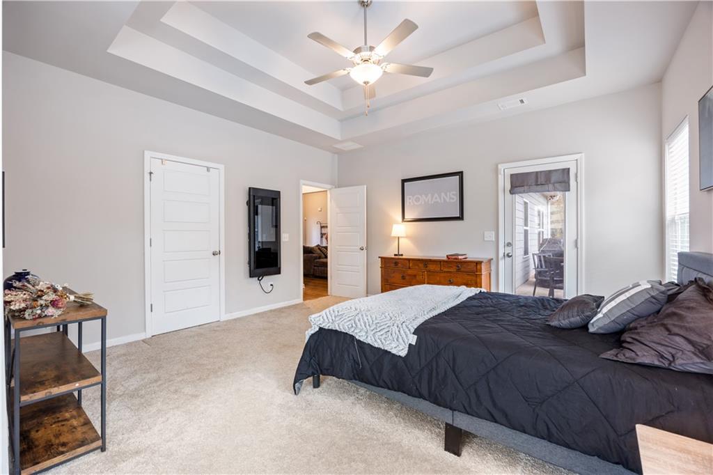 184 Ashford Lane Commerce, GA 30529 - Photo 10 of 49 a bedroom with a bed and a chandelier