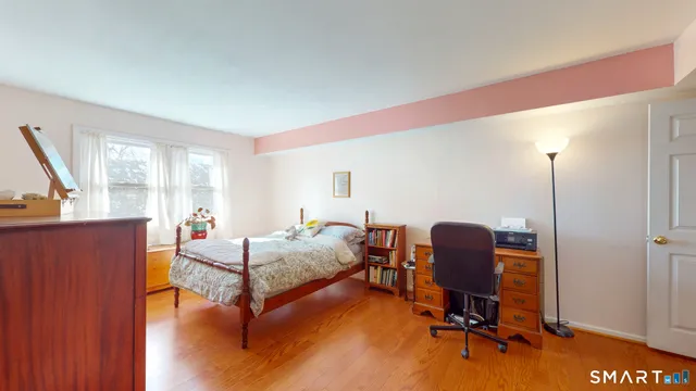 a livingroom with workspace and a window