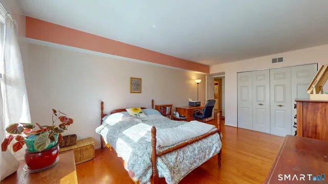 a bedroom with a bed and a dresser