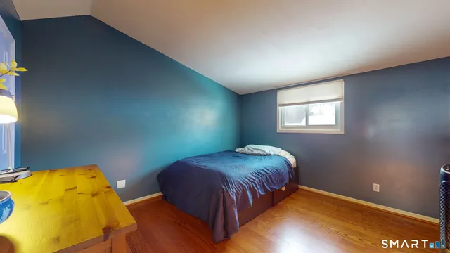 a bedroom with a bed and window