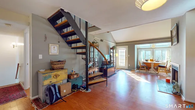 a living room with lots of furniture and a wooden floor