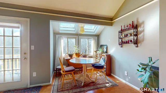 a dining room with furniture and wooden floor