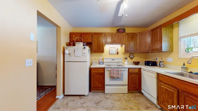 a kitchen with a sink refrigerator and cabinets