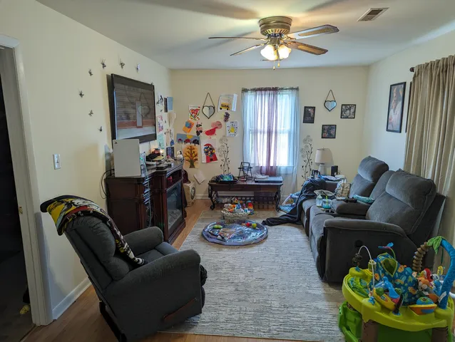 a living room with furniture flowerpot and window
