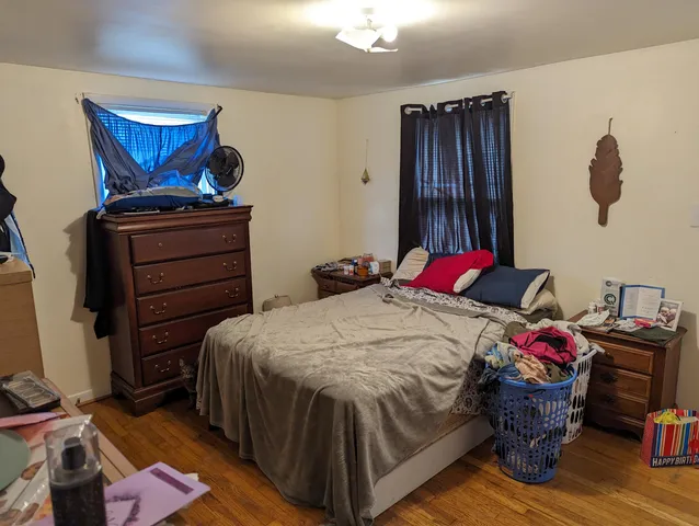 a bed sitting in a bedroom next to a window
