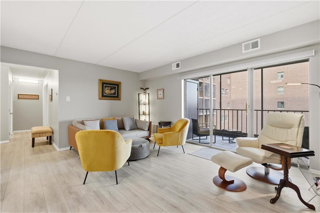 5600 Munhall Road, Unit 501 Pittsburgh, PA 15217 - Photo 15 of 37 Natural light illuminates the spacious living room with sliding doors to the private balcony.