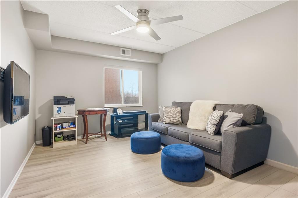 5600 Munhall Road, Unit 501 Pittsburgh, PA 15217 - Photo 28 of 37 Bedroom 2 features a ceiling fan and a spacious closet with frosted sliding doors.