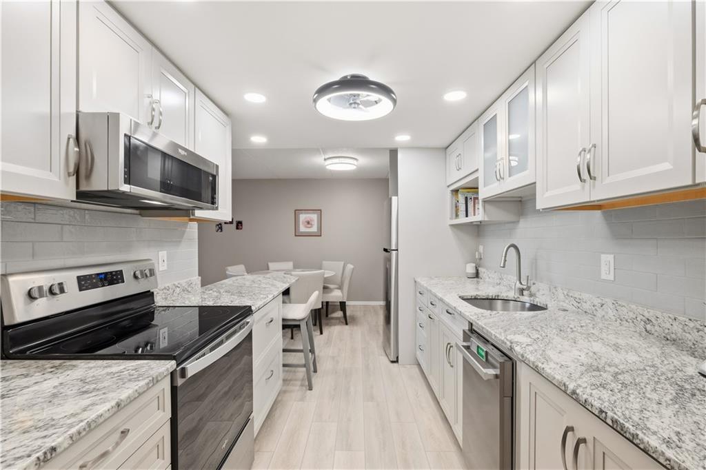 5600 Munhall Road, Unit 501 Pittsburgh, PA 15217 - Photo 9 of 37 Gorgeous, renovated kitchen with granite countertops, soft close cabinetry and modern stainless steel appliances.