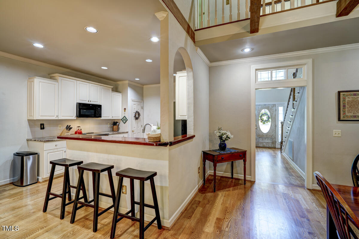 3725 Evander Way Raleigh, NC 27613 - Photo 10 of 35 a view of a dining room with furniture and wooden floor