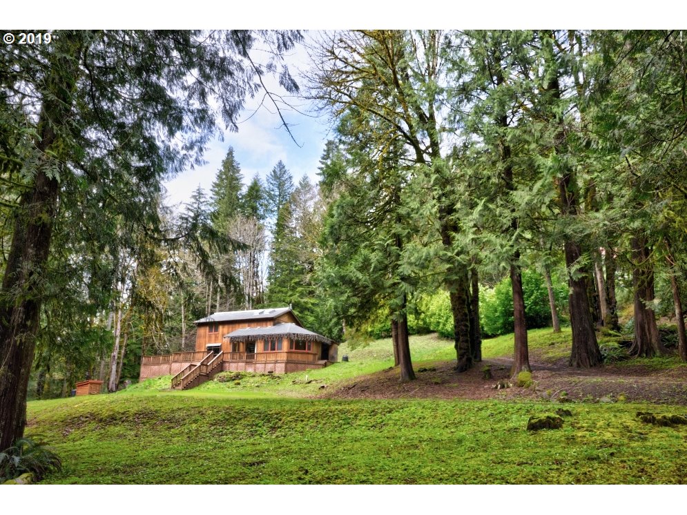 65333 East Barlow Trail Road Rhododendron, OR 97049 - Photo 1 of 31 a view of a house with a yard