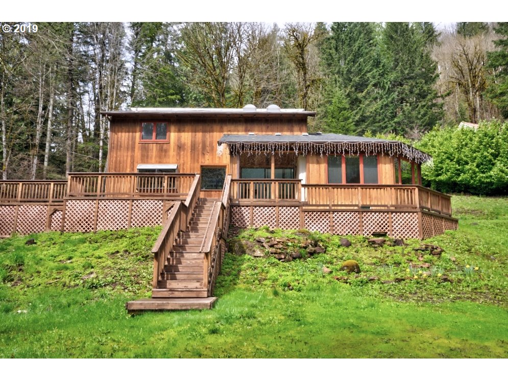 65333 East Barlow Trail Road Rhododendron, OR 97049 - Photo 2 of 31 a view of a house with a yard