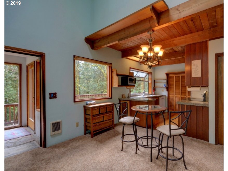 65333 East Barlow Trail Road Rhododendron, OR 97049 - Photo 5 of 31 a view of a dining room with furniture and chandelier