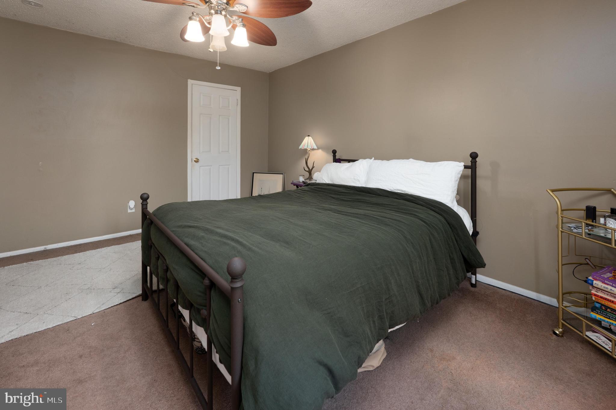 25 South Church Road, Unit 64 Maple Shade, NJ 08052 - Photo 14 of 21 a bedroom with a bed and a chandelier