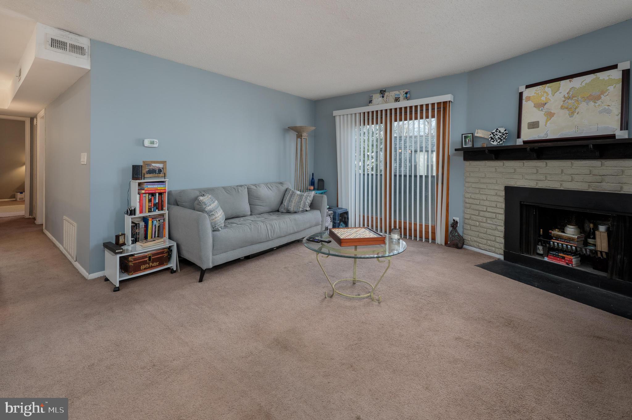 25 South Church Road, Unit 64 Maple Shade, NJ 08052 - Photo 2 of 21 a living room with furniture a window and a fireplace