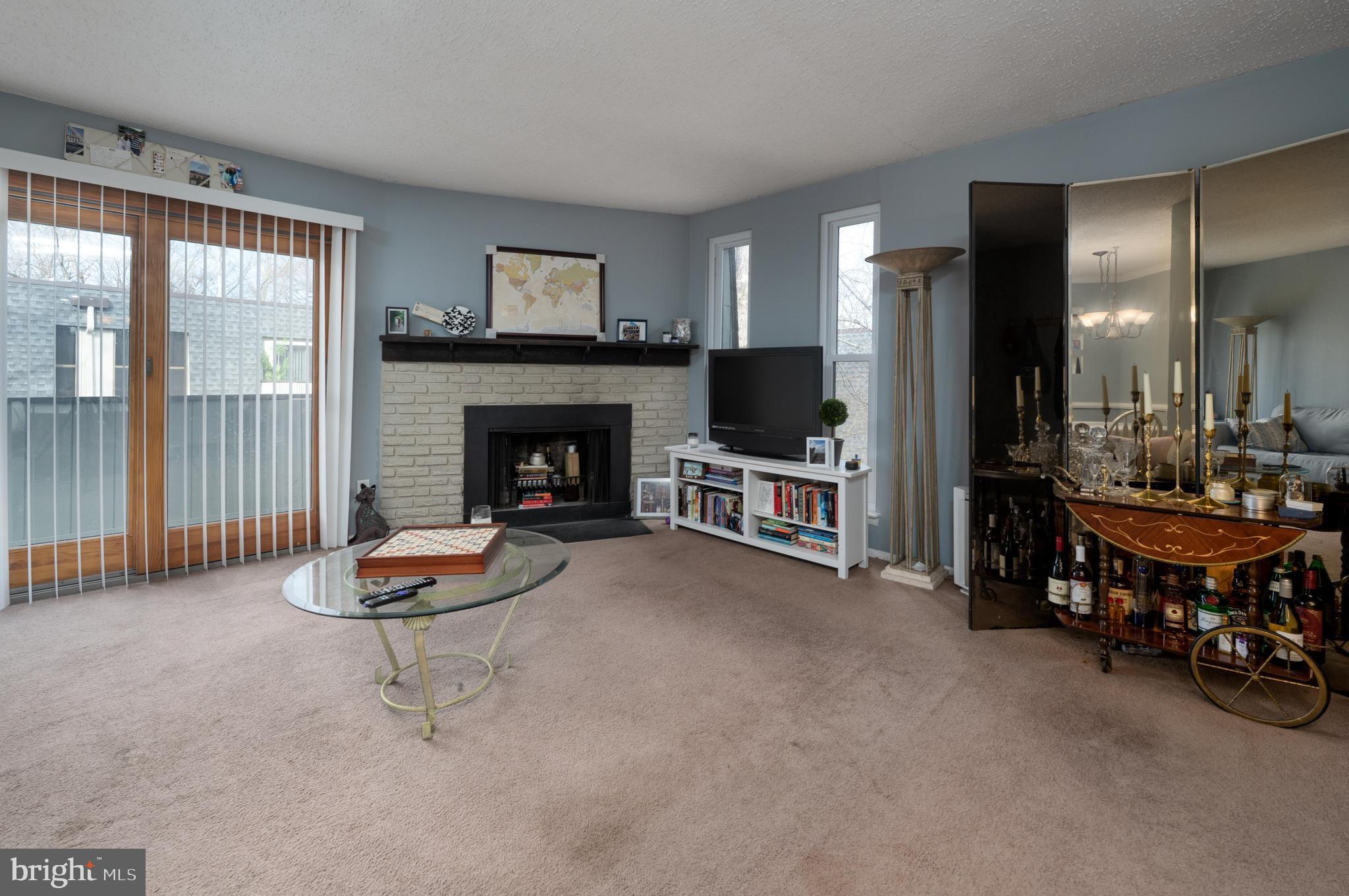 25 South Church Road, Unit 64 Maple Shade, NJ 08052 - Photo 4 of 21 a living room with furniture a fireplace and a flat screen tv