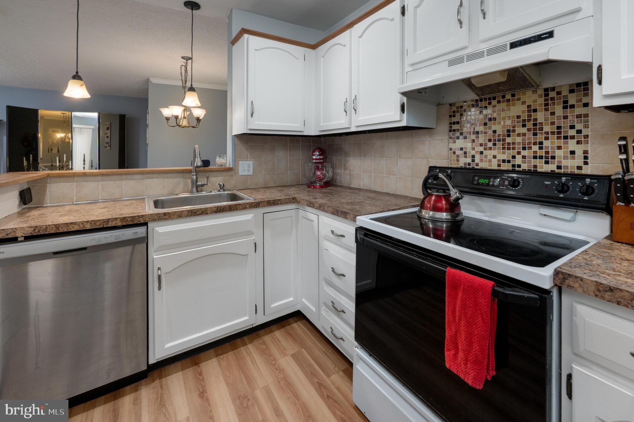 25 South Church Road, Unit 64 Maple Shade, NJ 08052 - Photo 7 of 21 a kitchen with stainless steel appliances granite countertop a sink a stove and a microwave