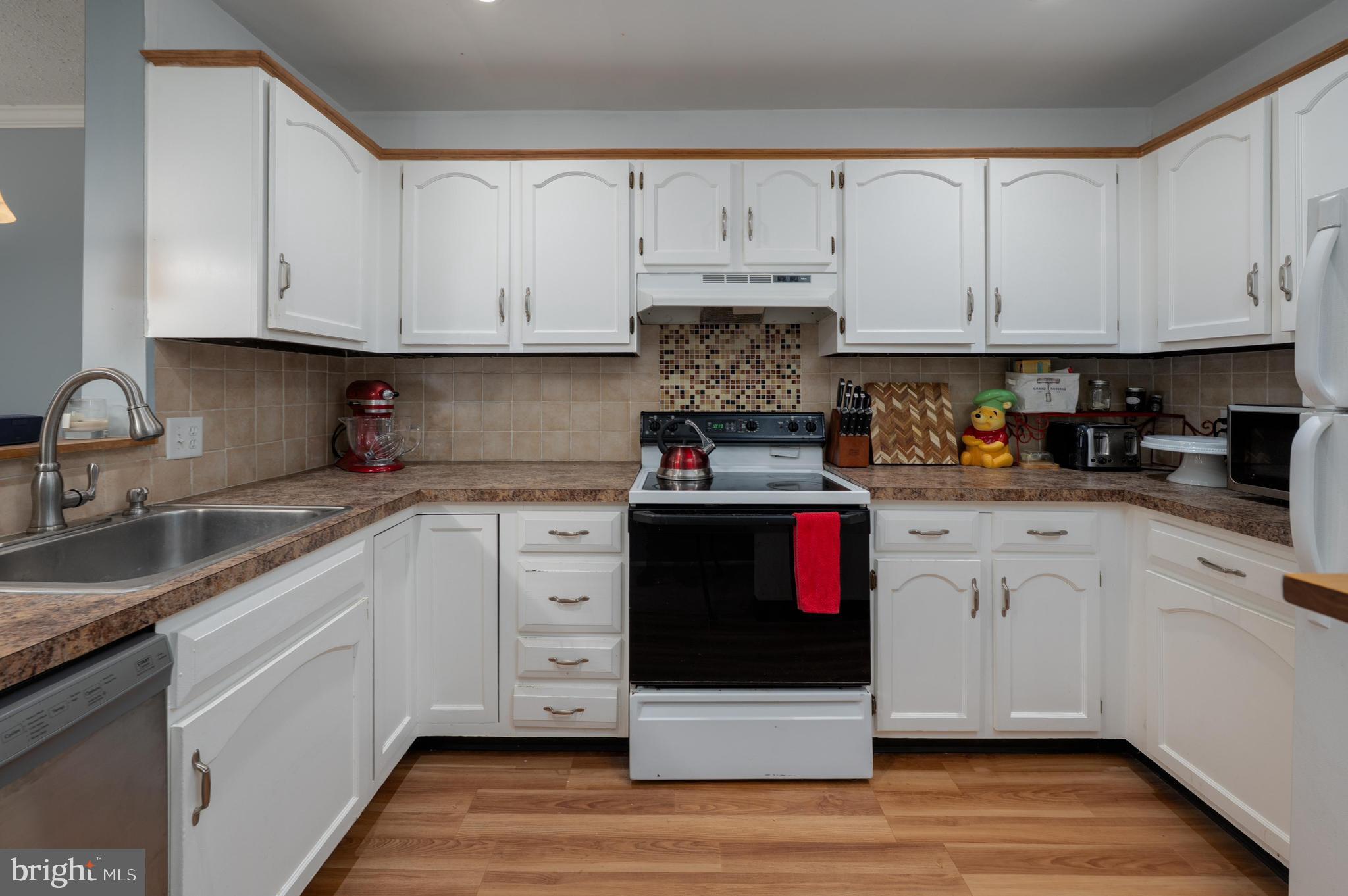 25 South Church Road, Unit 64 Maple Shade, NJ 08052 - Photo 8 of 21 a kitchen with stainless steel appliances granite countertop white cabinets sink and stove