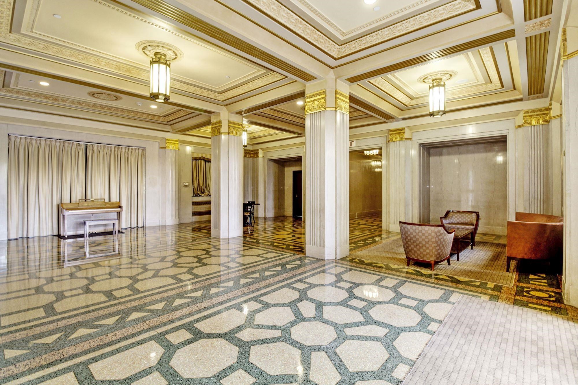 4 Beacon Way, Unit 301 Jersey City, NJ 07304 - Photo 20 of 26 a living room with lots of furniture and a chandelier