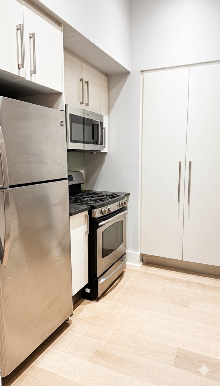 4 Beacon Way, Unit 301 Jersey City, NJ 07304 - Photo 4 of 26 a kitchen with stainless steel appliances a refrigerator and a stove